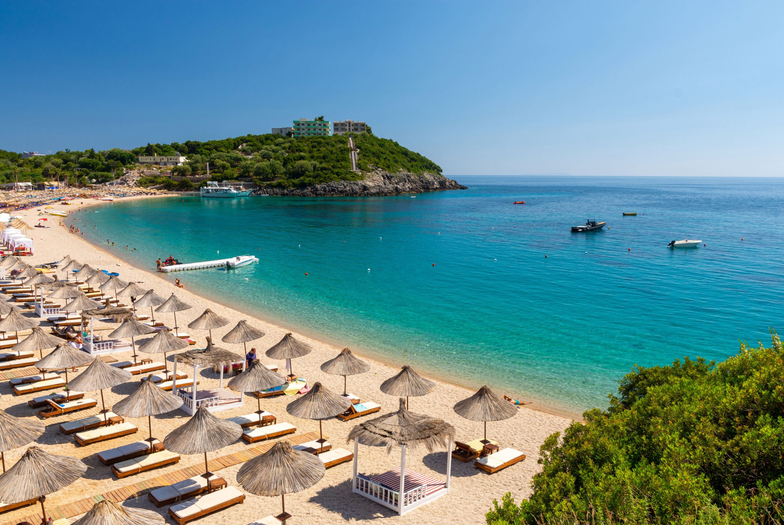 aerial shot of jale beach albania sun chairs and umbrellas on beach