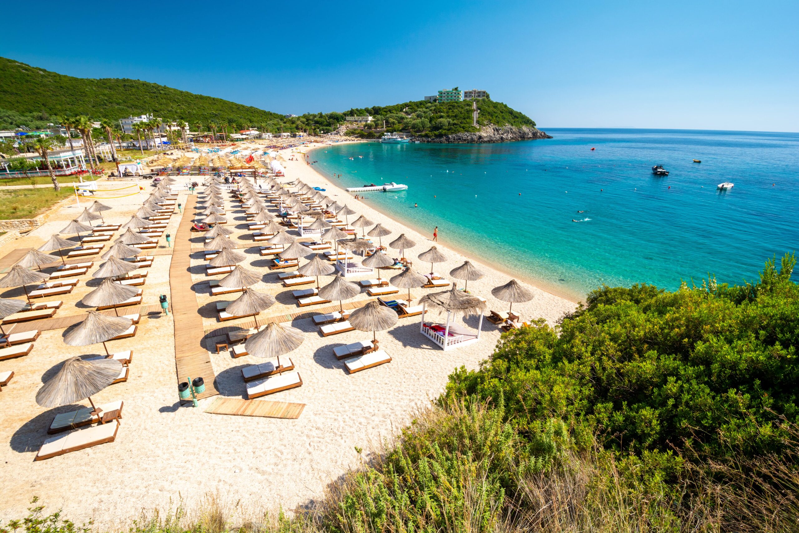 beach of jale albania with sunchairs on the shore