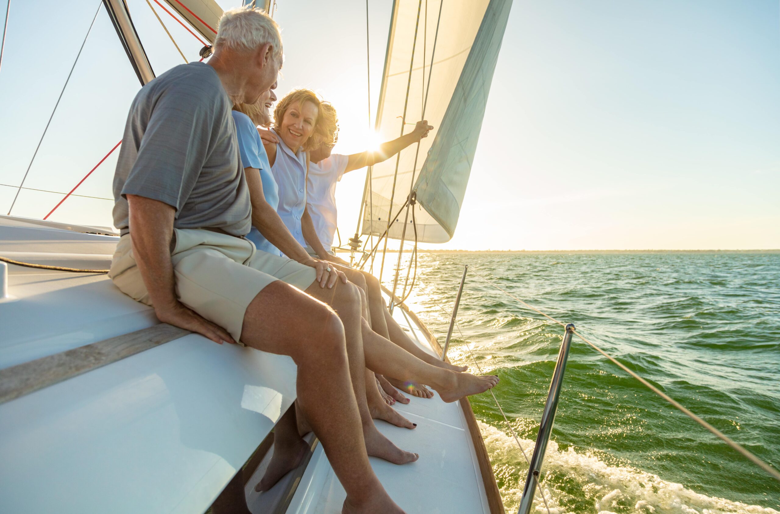 retirees on side of a boat on green blue waters
