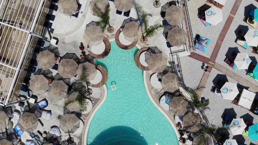 aerial view of pool with umbrellas around it